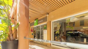 A hotel entrance with a glass door, a sign for 'ibis Styles', and a potted plant on the left. - ibis Styles Nice Vieux Port (Nice)