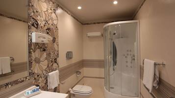A bathroom with a shower, toilet, and sink.