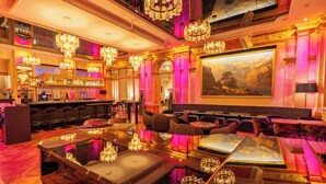 A luxurious lobby with a bar, seating area, and a large painting on the wall. - Hotel Schweizerhof Luzern (Lucerne)