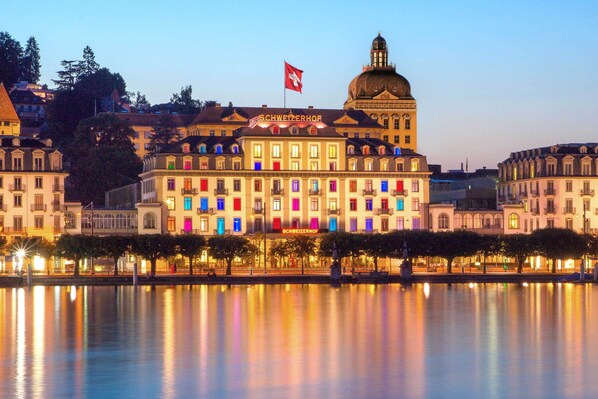 Hotel Schweizerhof boasts a classic European facade with a central dome and large windows overlooking Lake Zurich.