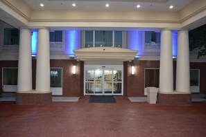A building entrance with a covered walkway, columns, and a glass door. - Holiday Inn Express & Suites Gainesville by IHG (Gainesville)