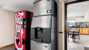 A kitchen area with a refrigerator and a Coca-Cola branded vending machine. - SureStay Hotel by Best Western Manchester (Manchester)