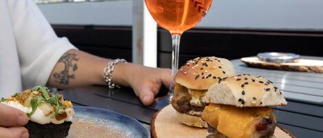 Una mesa con comida y una copa de vino.