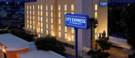 A City Express by Marriott hotel with a modern design, multiple floors, and a well-lit entrance.