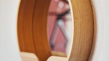 A wooden wall-mounted shelf with a circular opening.