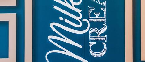 A framed sign with the words "Milk Cream" in stylized text.