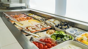 A buffet with various food items including meats, cheeses, fruits, and vegetables. - rugs HOTEL Köln (Cologne)