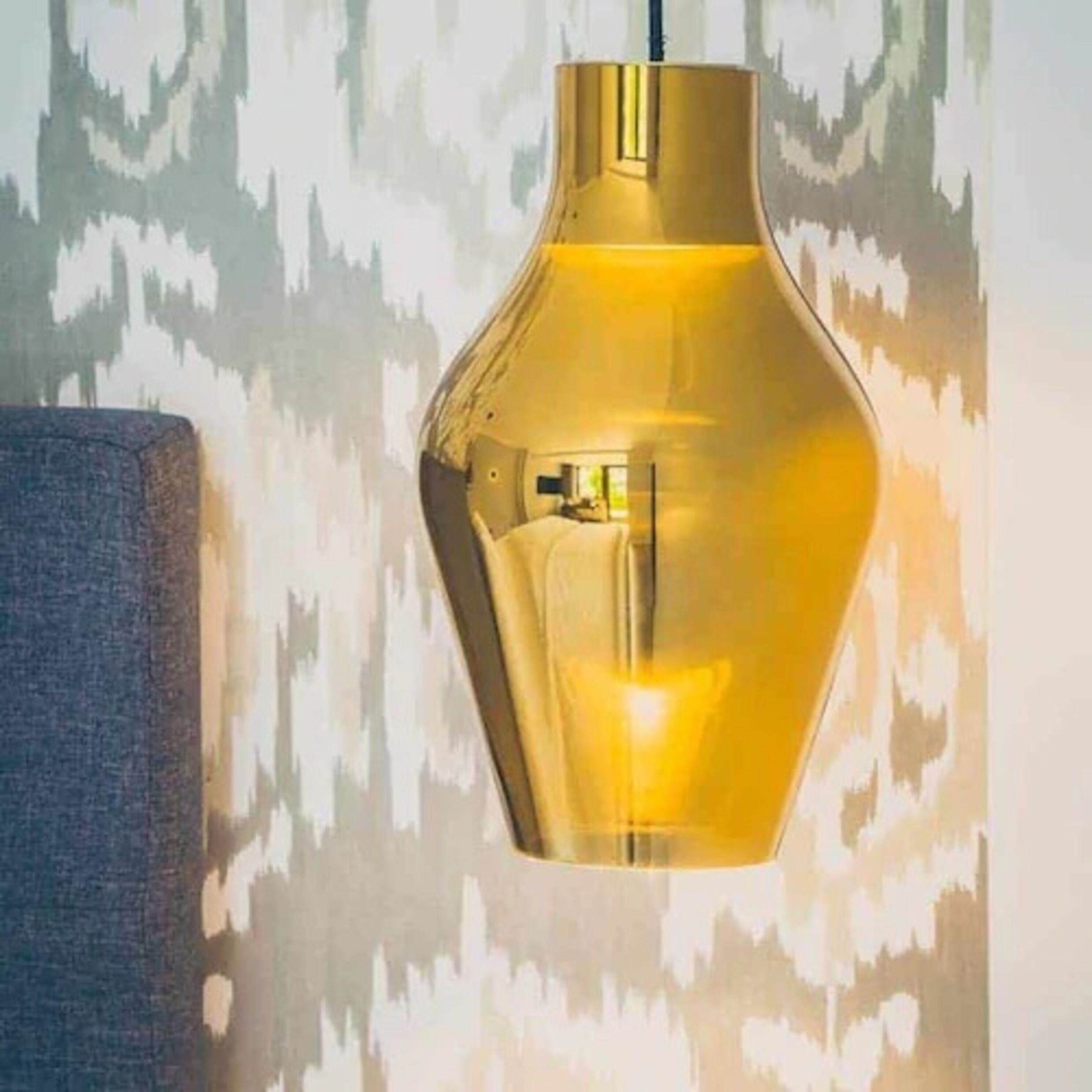 A pendant light fixture with a metallic finish.