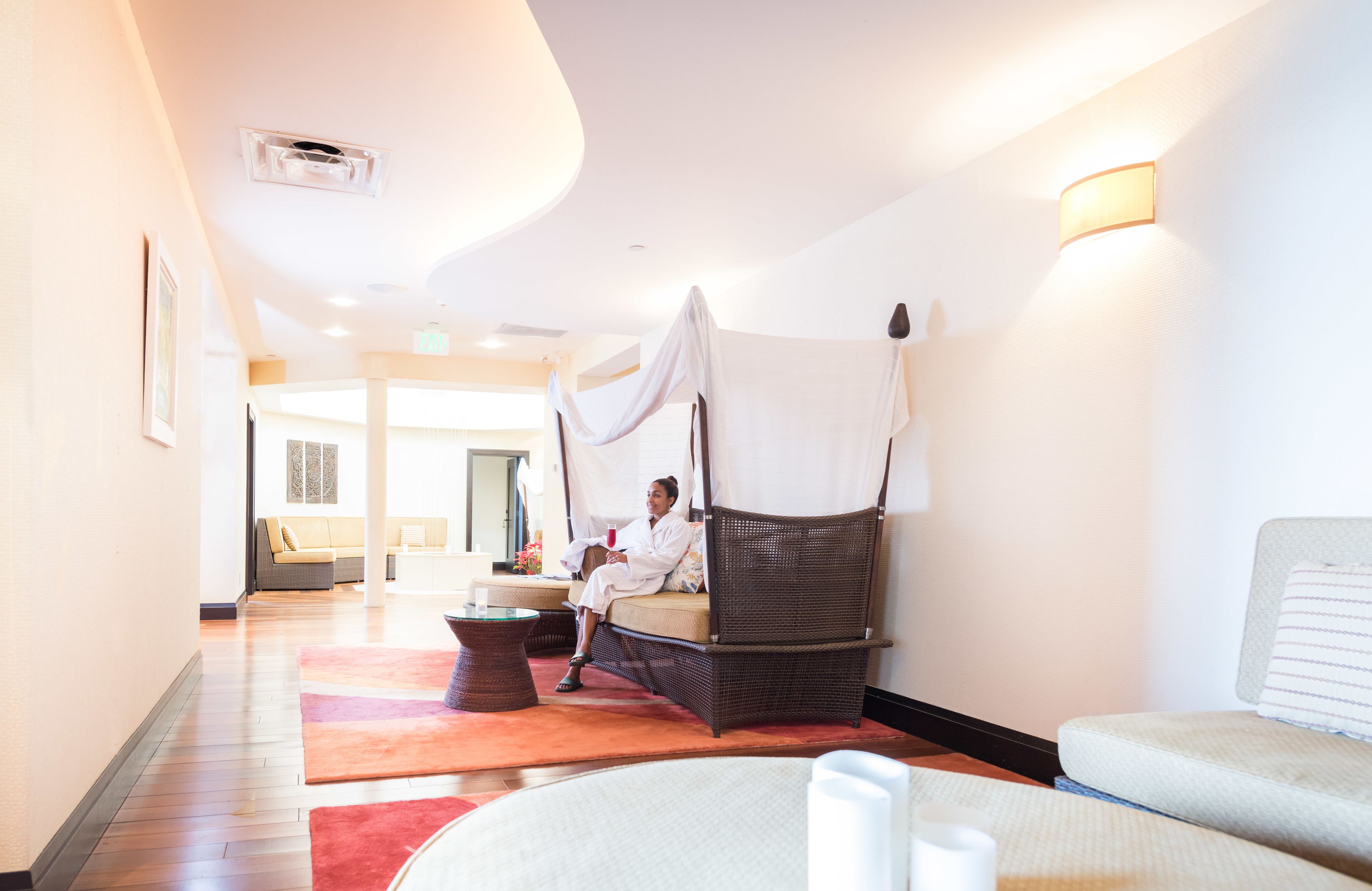 A room with a large bed, a sofa, and a small table.