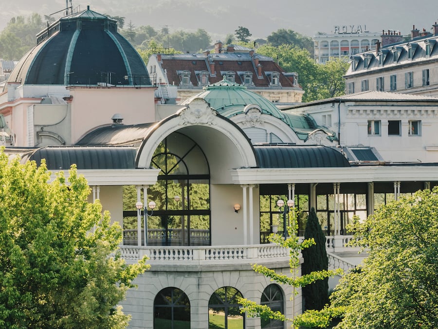 A large building with a prominent dome and a covered walkway.