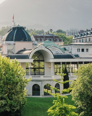 A large building with a prominent dome and a covered walkway.