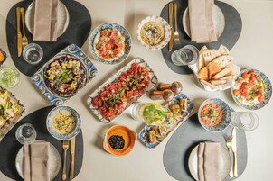 A table set for a meal with various dishes, plates, and cutlery.