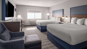 A hotel room with two beds, a desk, a chair, a TV, and a window. - AmericInn by Wyndham Shakopee Near Canterbury Park (Shakopee)