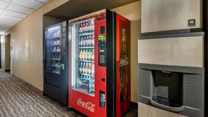 A hotel corridor with a Coca-Cola vending machine and a water dispenser. - Comfort Inn Story City (Story City)