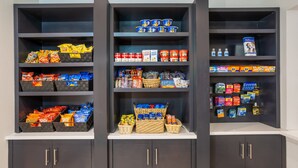 A storage unit with multiple shelves containing snacks, beverages, and household items.