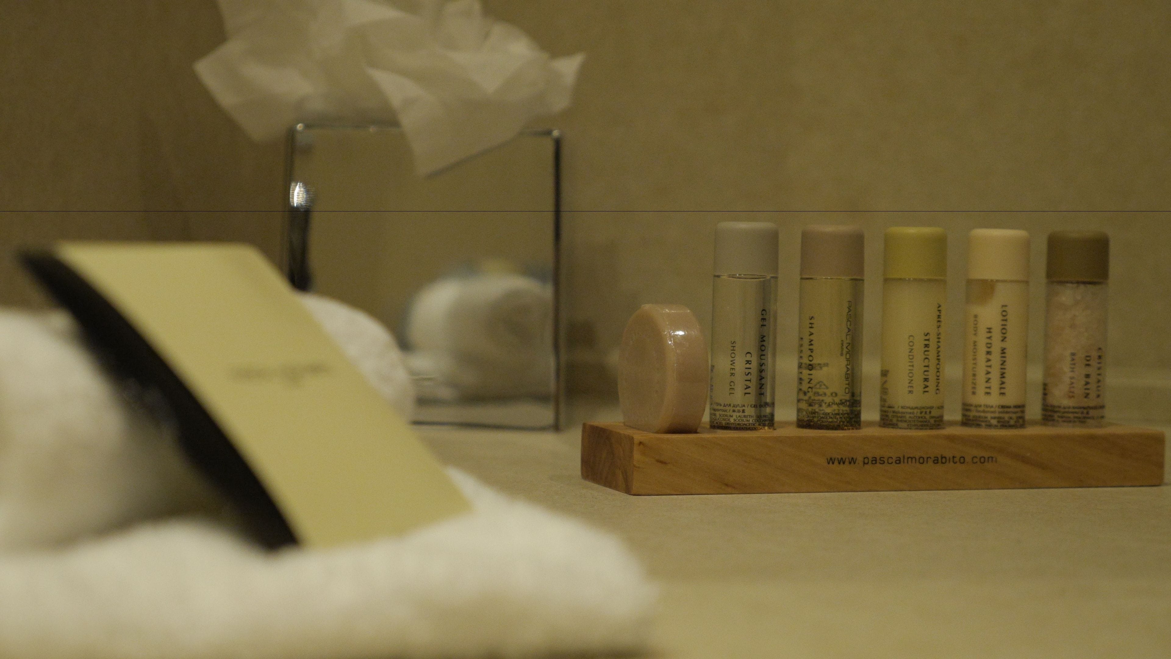 designer toiletries, hair dryer, towels, shampoo