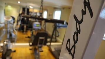 A gym with exercise equipment and a sign that reads "Badg".