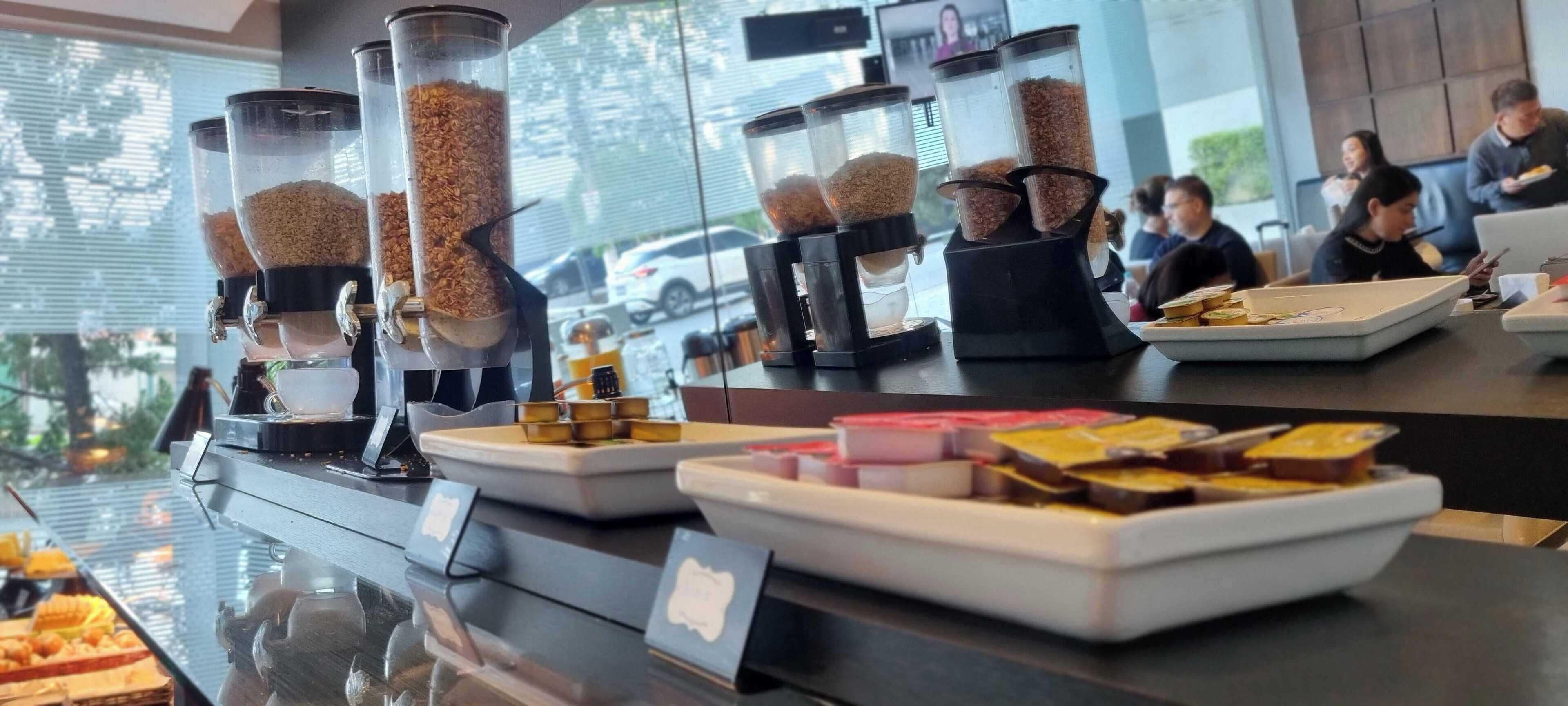 A breakfast buffet with various food items and a coffee station.