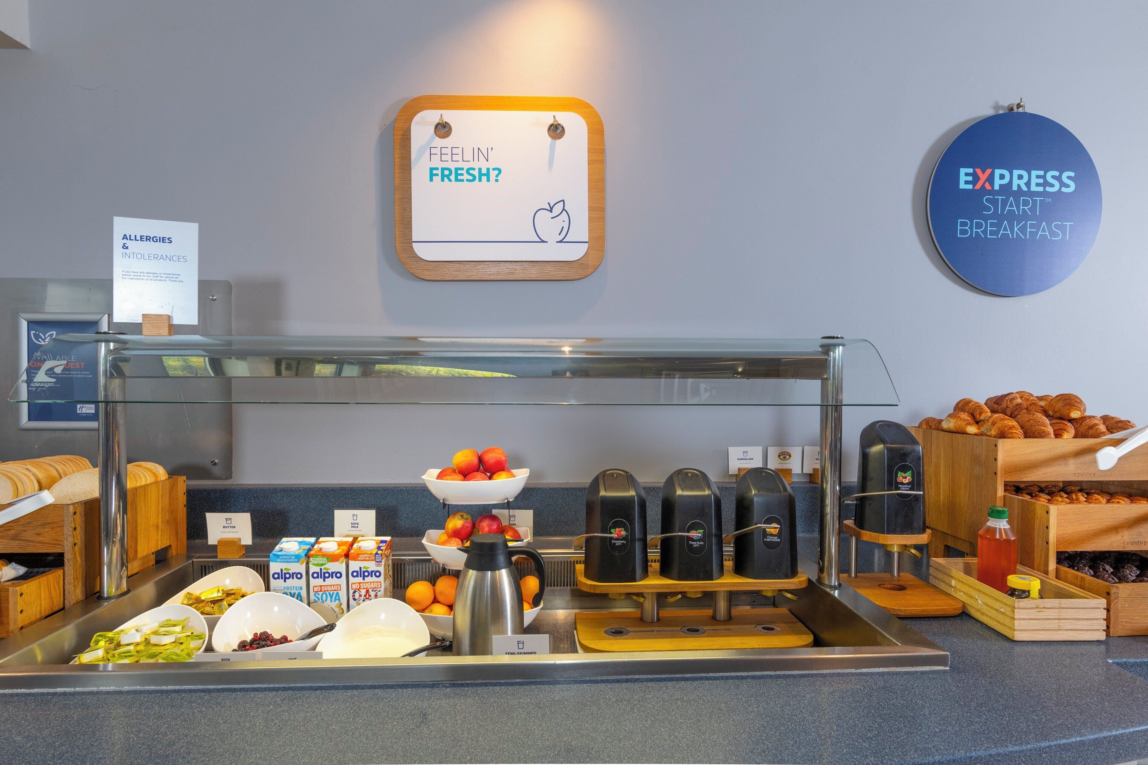 A breakfast buffet with various food items and a coffee station.
