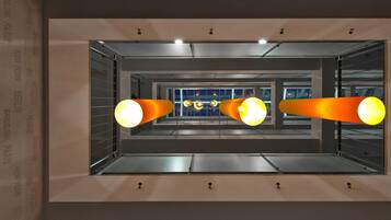 A modern interior with a central reflective surface and three large, cylindrical light fixtures.