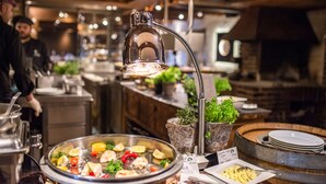 A buffet setup with various dishes and a beverage station.