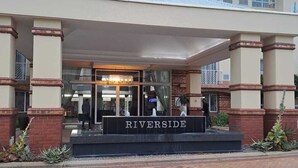 A hotel entrance with a sign reading "RIVERSIDE." - The Riverside Hotel (Durban North)