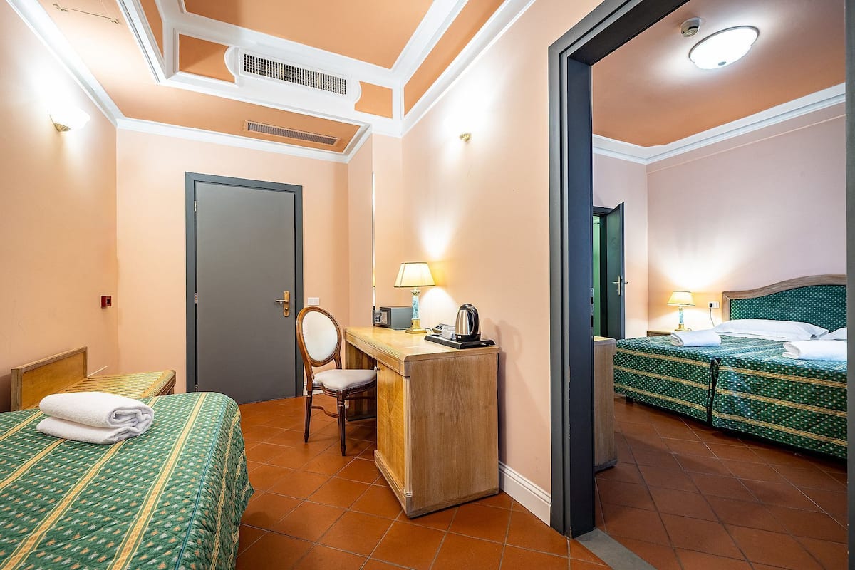 Family Triple Room | Minibar, in-room safe, desk, blackout drapes
