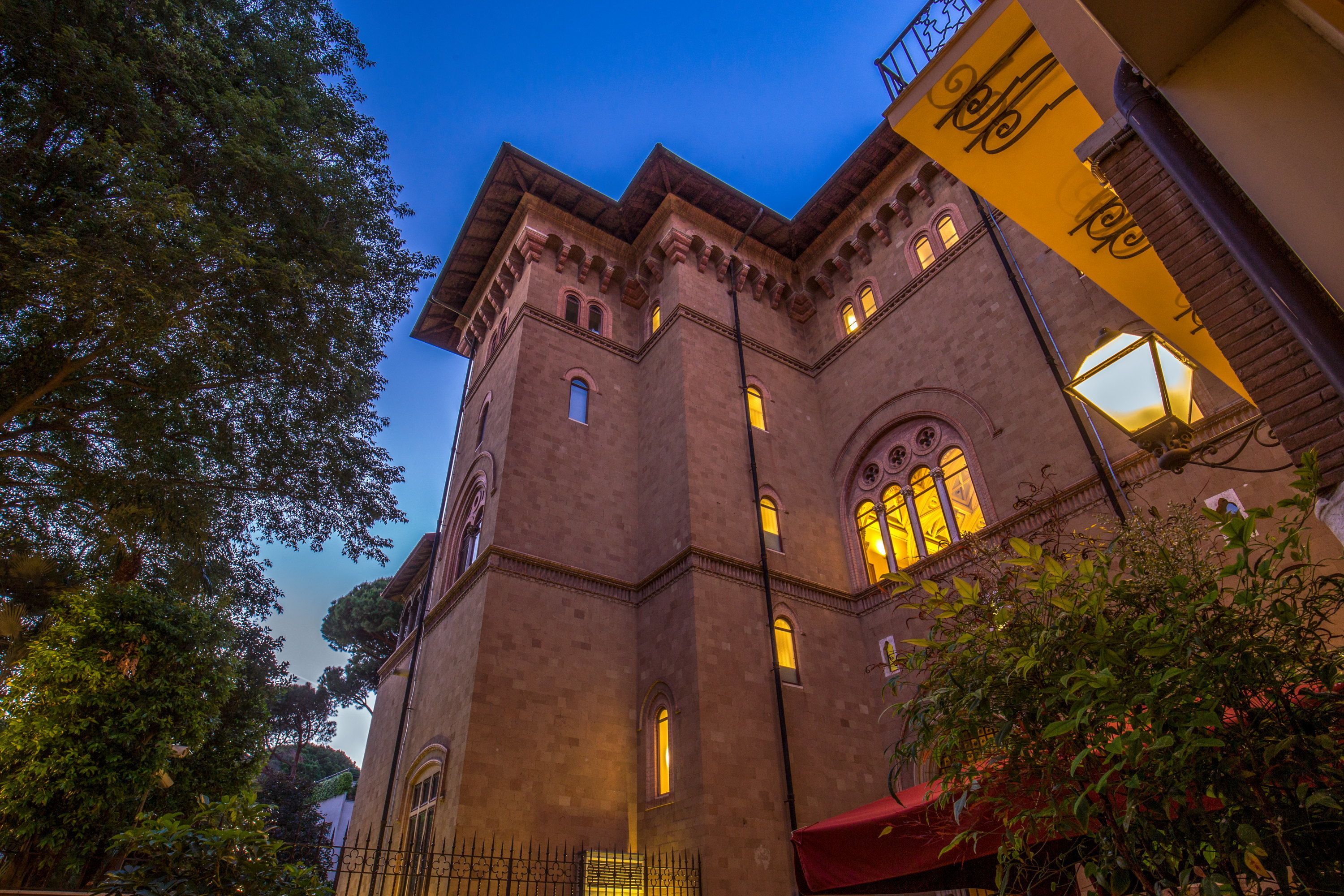 A historic building with arched windows and a tower.