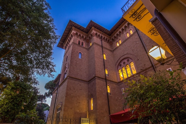 A historic building with arched windows and a tower.