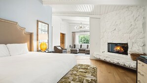A bedroom with a large bed, a fireplace, and a view of the outdoors. - Pacific Crest Hotel Santa Barbara (Santa Barbara)