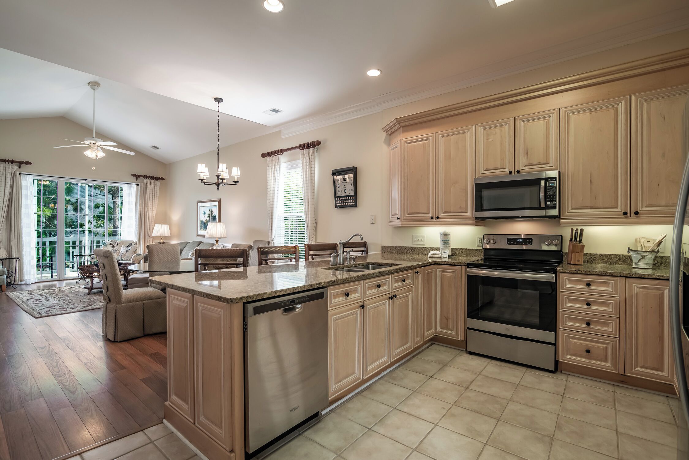 A spacious kitchen with wooden cabinets, stainless steel appliances, and a large island.