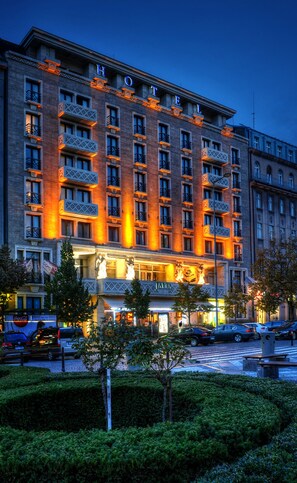 A hotel with multiple floors, balconies, and a well-lit facade. - Jalta Boutique Hotel (Prague)