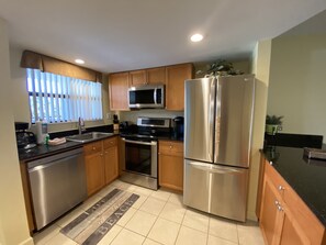Gulf View Condo 205 | Private kitchen | Full-size fridge, microwave, oven, stovetop