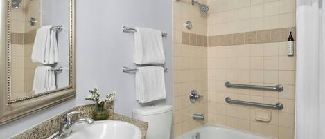 A bathroom with a sink, toilet, and bathtub.