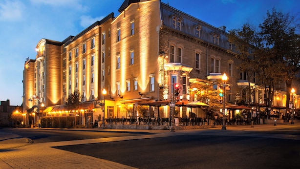 A historic hotel with multiple floors, large windows, and a well-lit facade. - Hotel Chateau Laurier Quebec (Québec City)