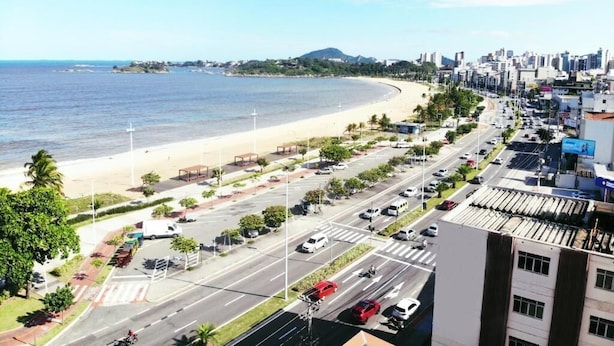 A coastal cityscape with a beach, roads, and buildings. - Vitória Praia (Vitoria)
