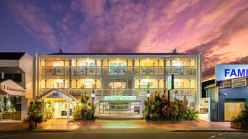 A hotel with a balcony, a sign reading "City Terraces," and a "Keep Clear" marking on the road.