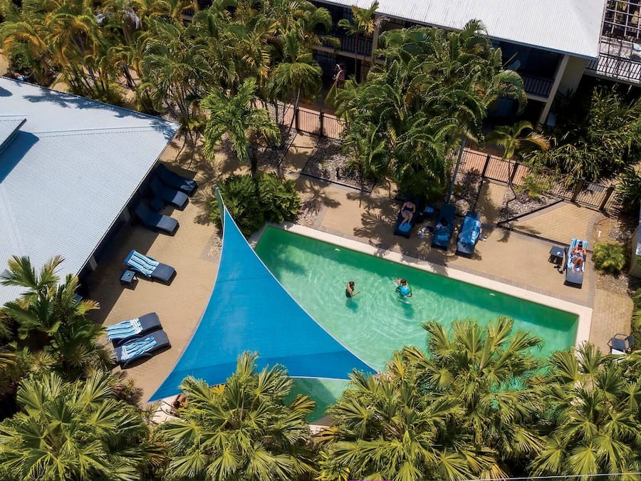 Una piscina al aire libre, sillones reclinables de piscina