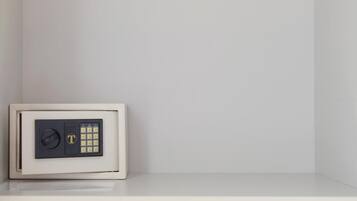 A safe with a keypad and a lock on a white wall.