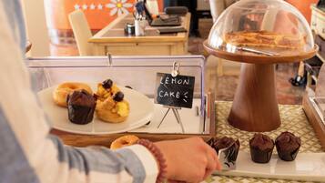 Vitrine de pastelaria com bolos de limão e muffins.