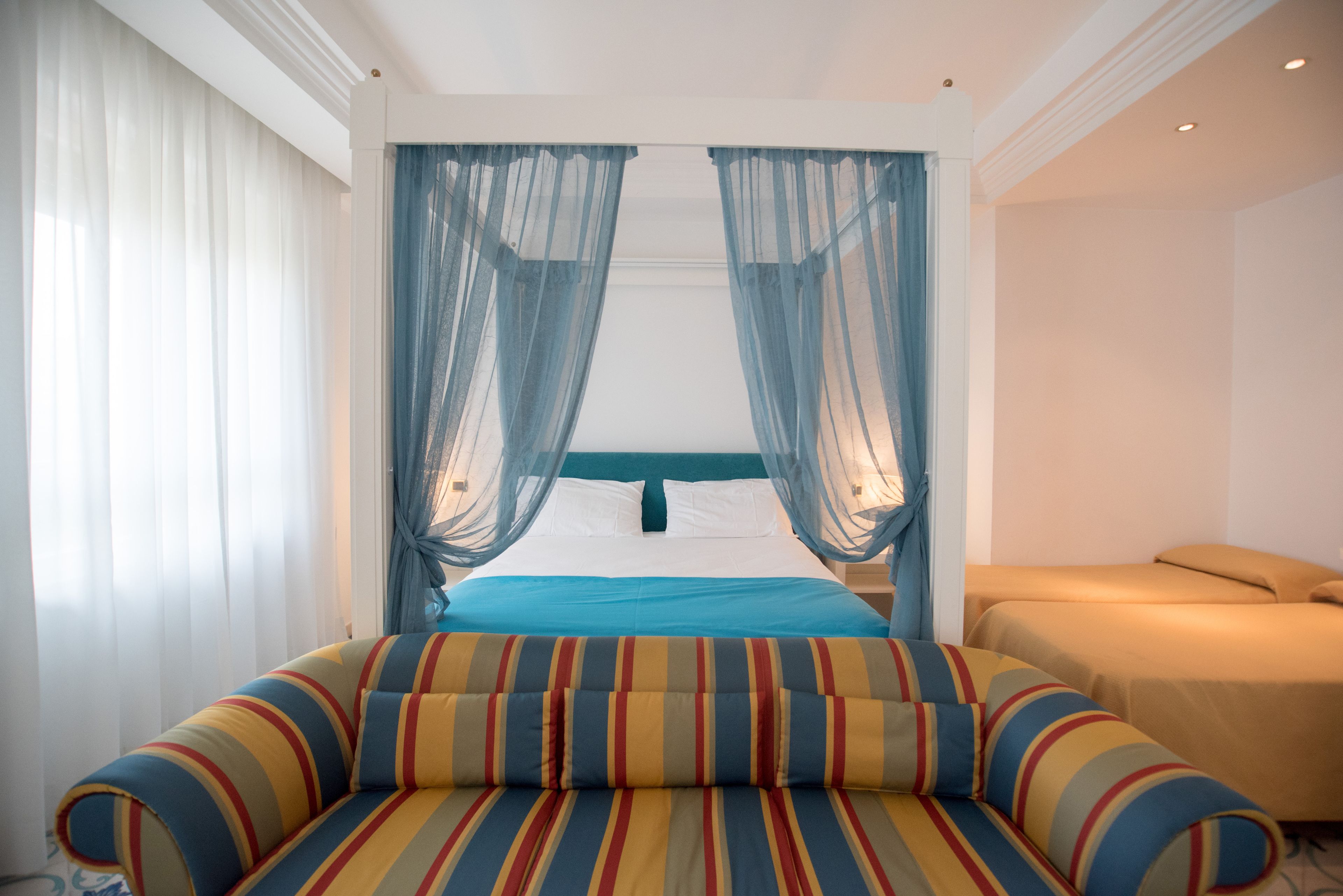 Junior Suite, Partial Sea View | Down duvets, minibar, desk, blackout curtains