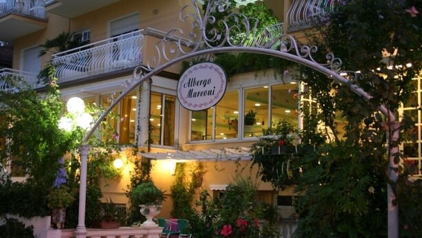 A building with a sign reading "Albergo Mareoni" and a balcony with white railings. - Marconi (Cattolica)