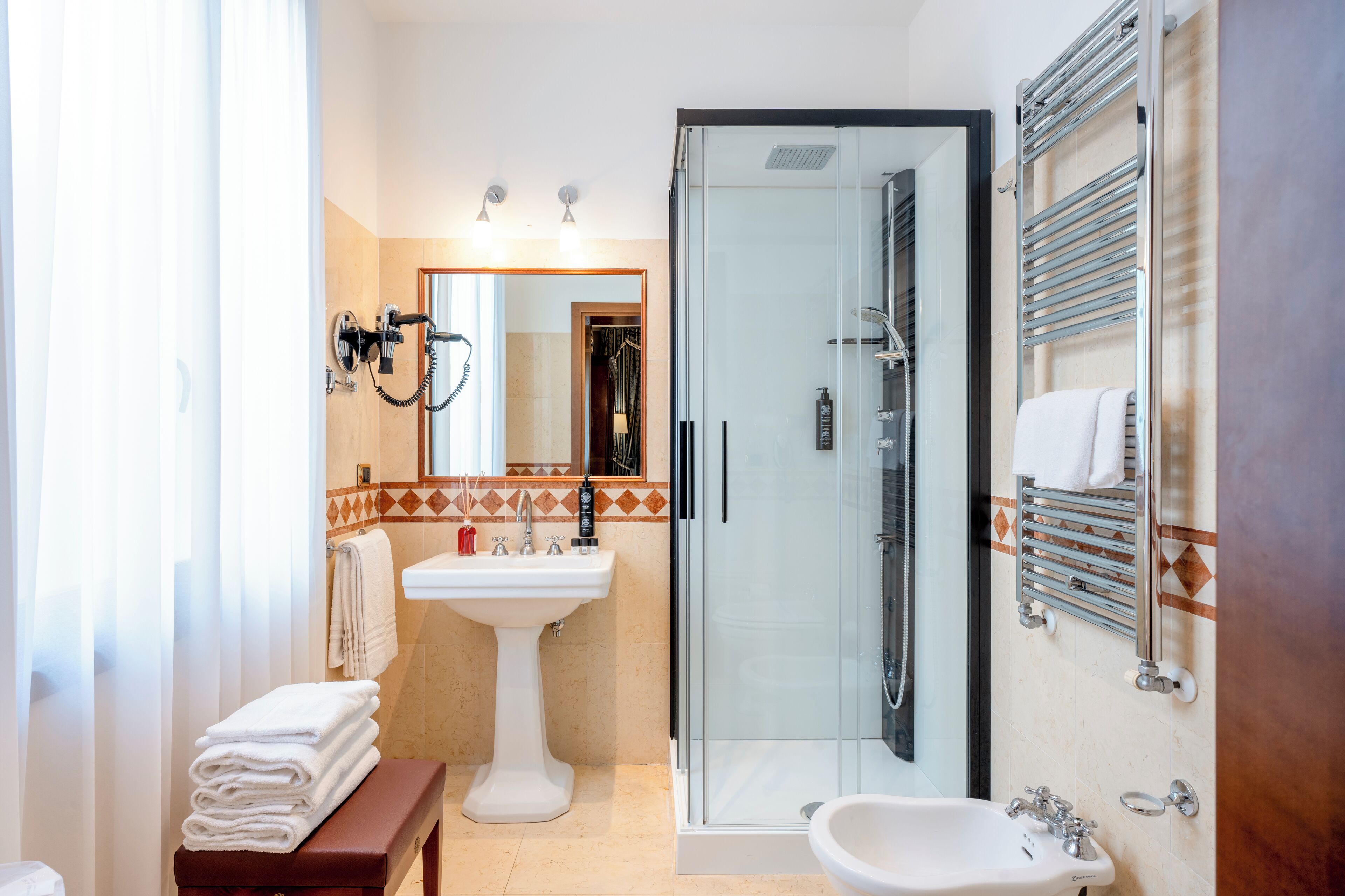 junior suite | bathroom | hair dryer, slippers, bidet, towels