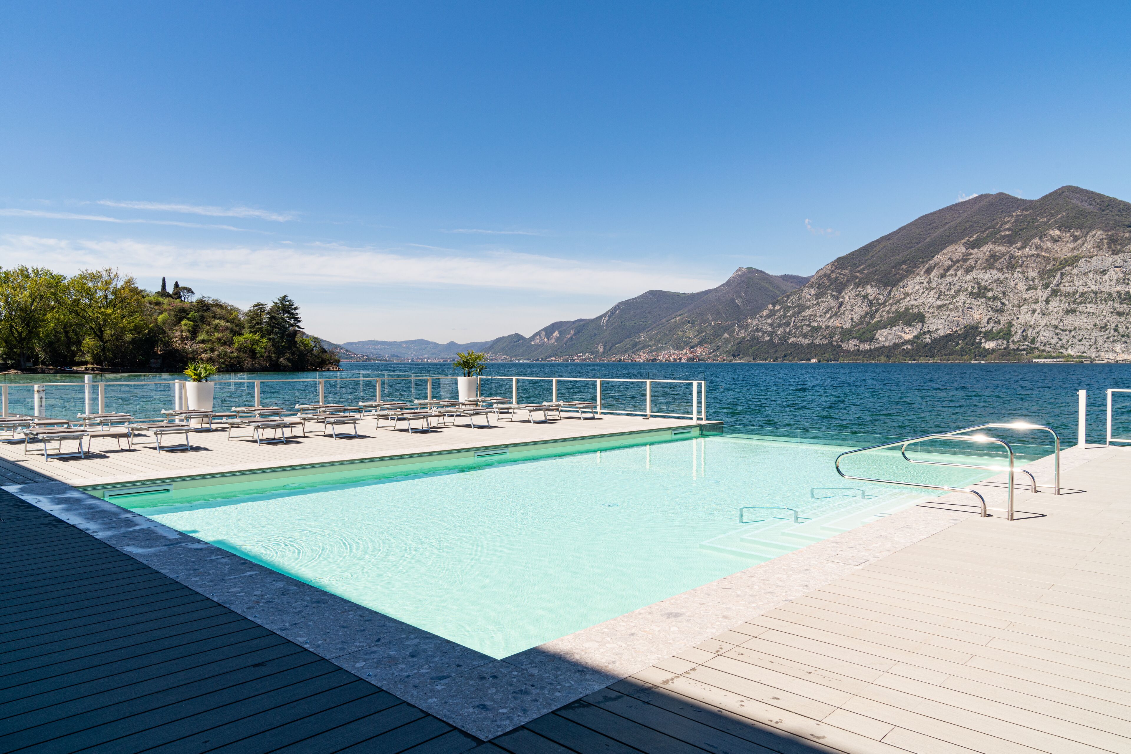 Una piscina con vistas al mar y a las montañas.