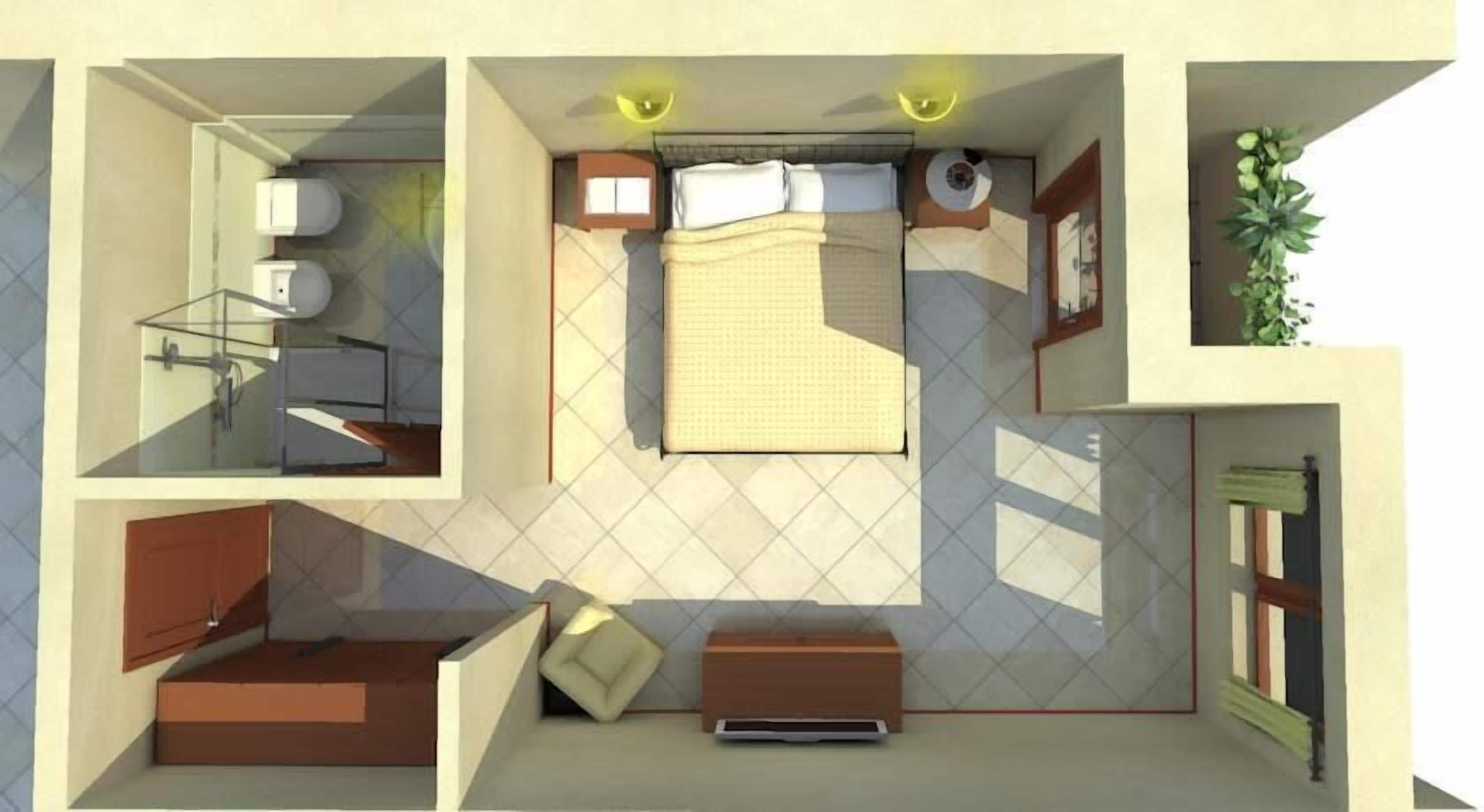 Stanza compatta con letto, comodino e un piccolo angolo salotto. Una finestra lascia entrare luce naturale e una pianta aggiunge un tocco di verde.