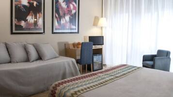 Habitación triple | Minibar, caja de seguridad en la habitación y escritorio