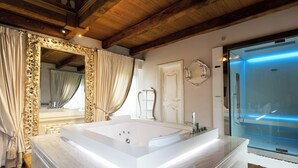 A modern bathroom with a large freestanding bathtub, a glass shower enclosure, and ornate mirrors.