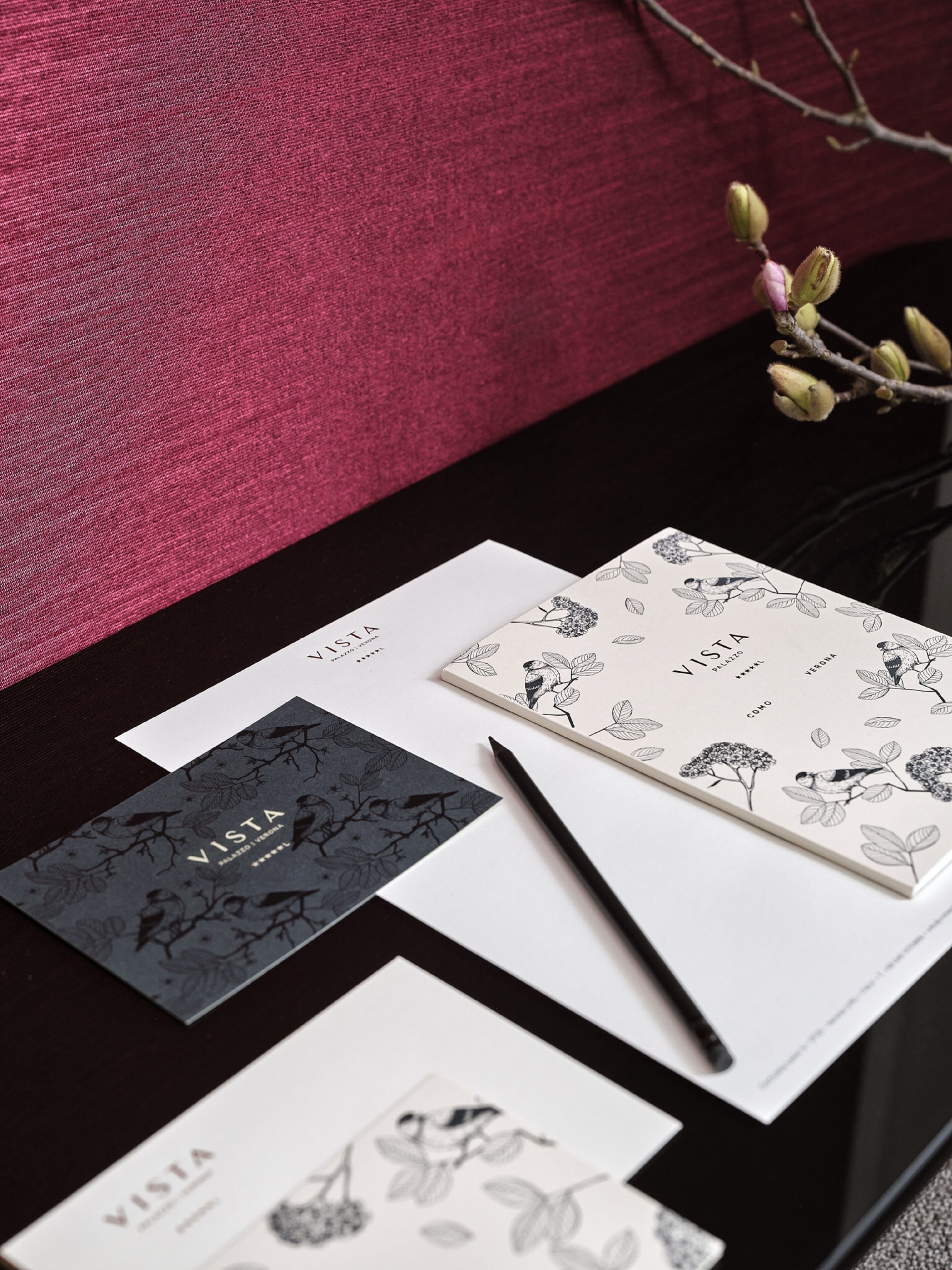 A desk with business cards, a notebook, and a pen.