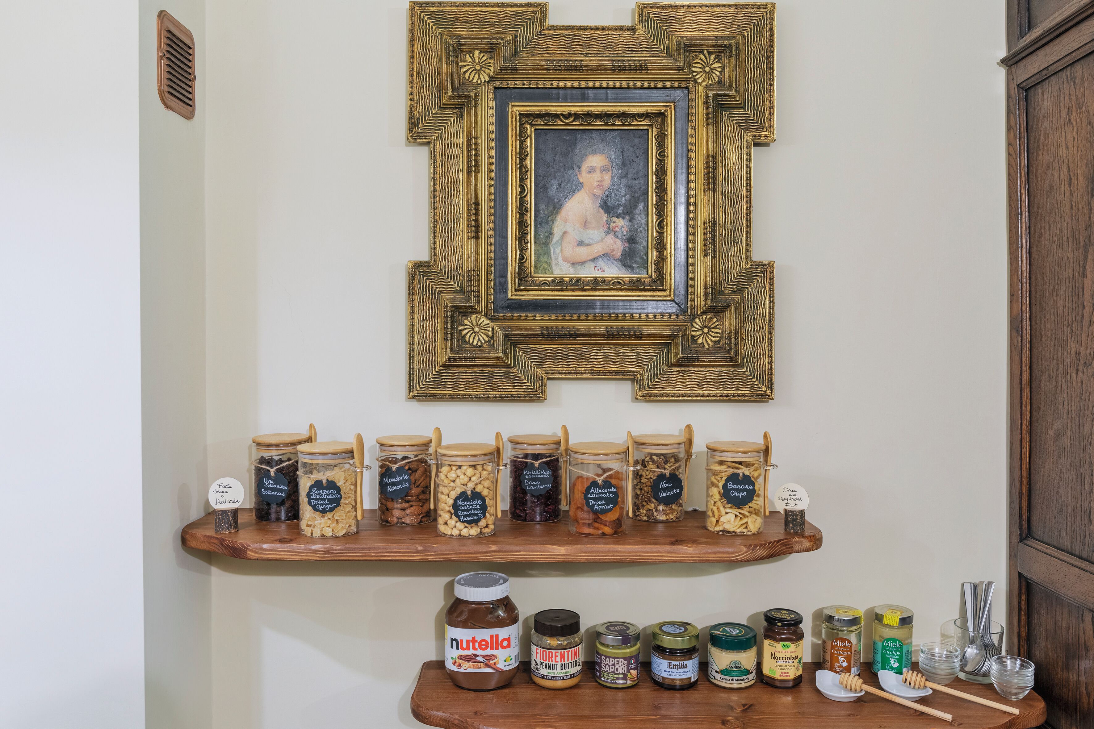 A shelf with various jars of food items and a Nutella jar.