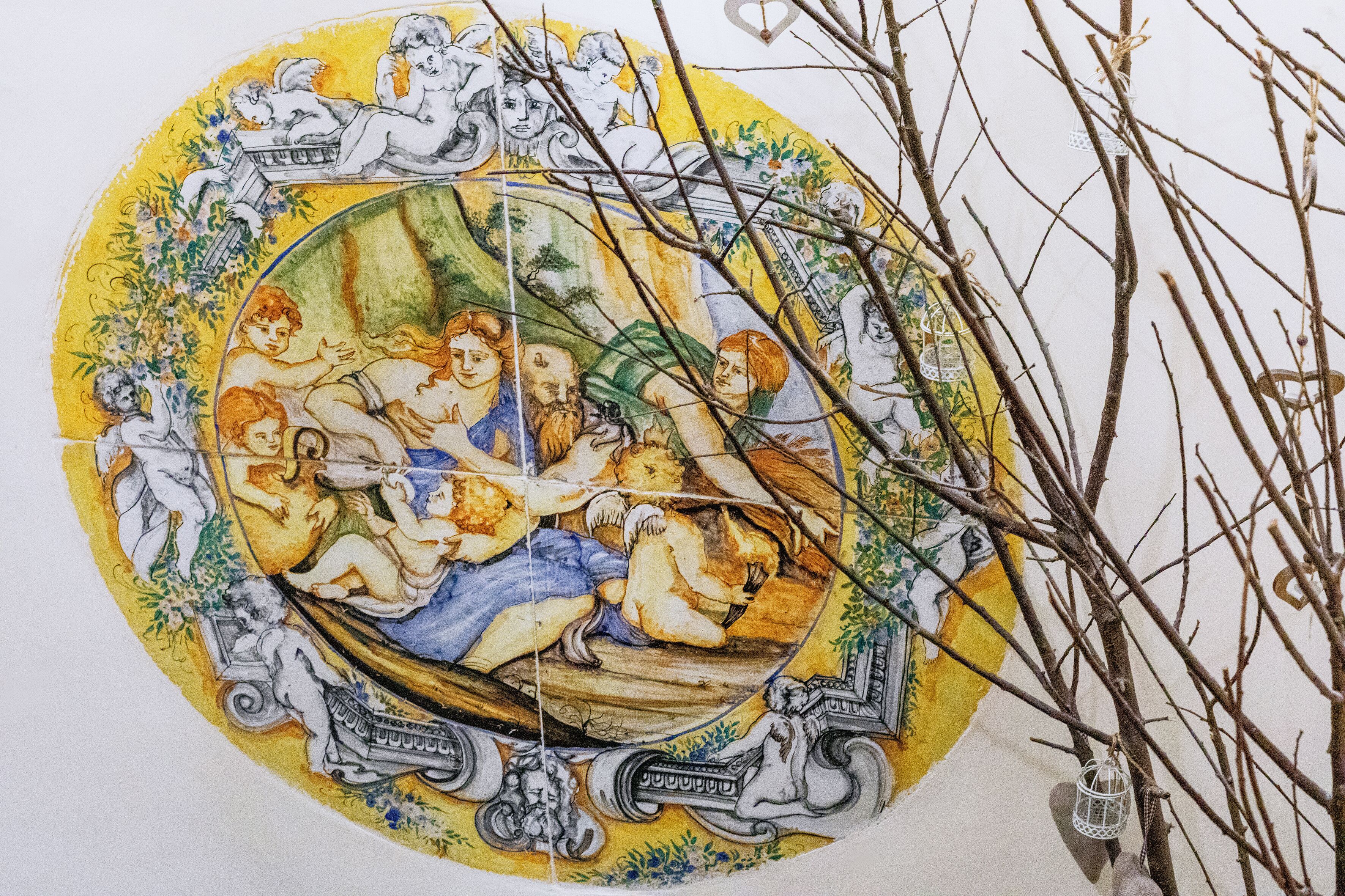 A detailed mural with classical figures and architectural elements.